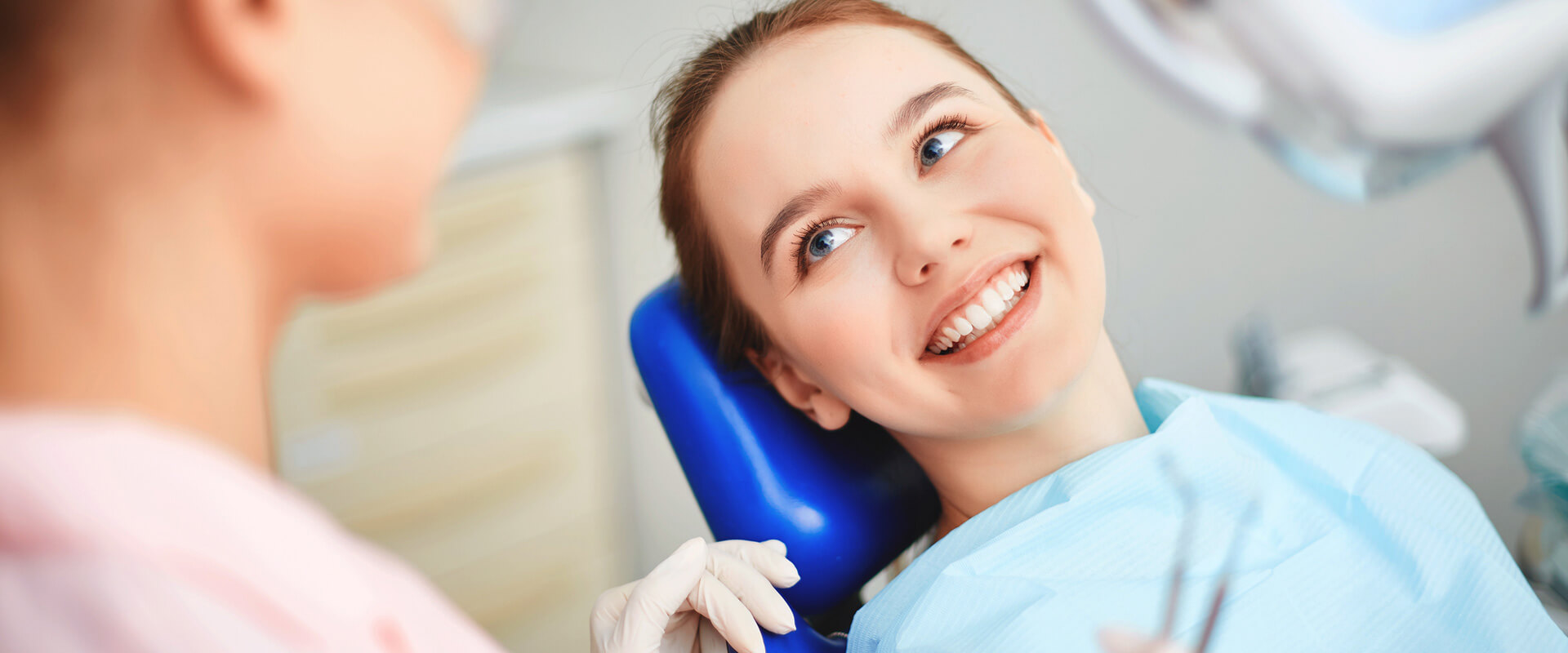 Woman smiling seated in dental chair